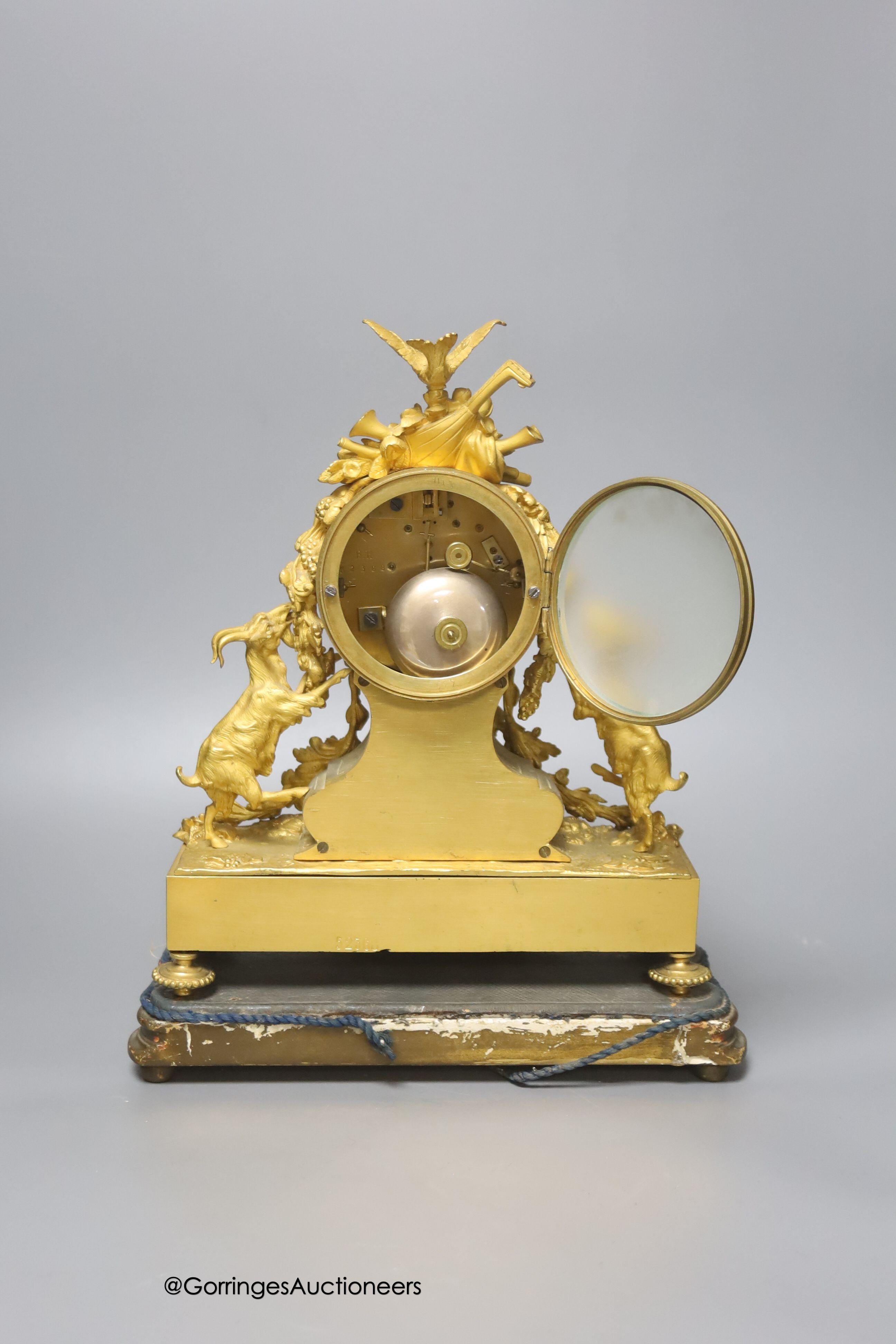 A 19th century French ormolu and porcelain mantel clock, with key and pendulum, overall height 33cm